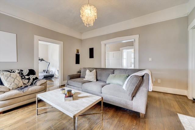 1202 Hickman Rd, Augusta, GA 30904 - living area featuring wood finished floors, a chandelier, and baseboards