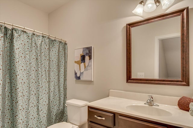 bathroom with vanity, curtained shower, and toilet