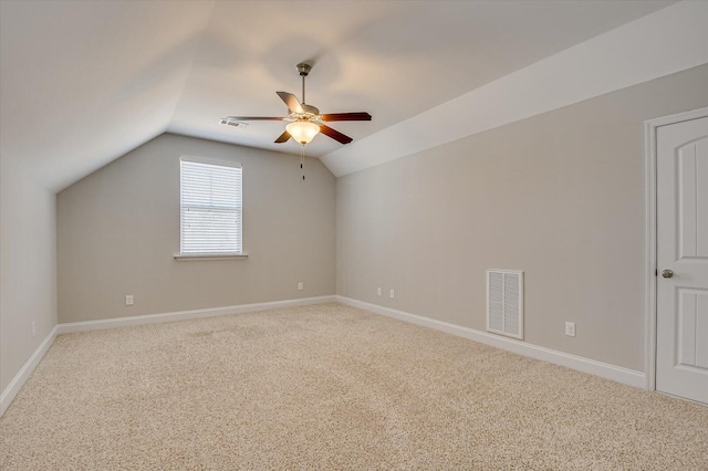 bonus room featuring carpet, visible vents, baseboards, ceiling fan, and vaulted ceiling