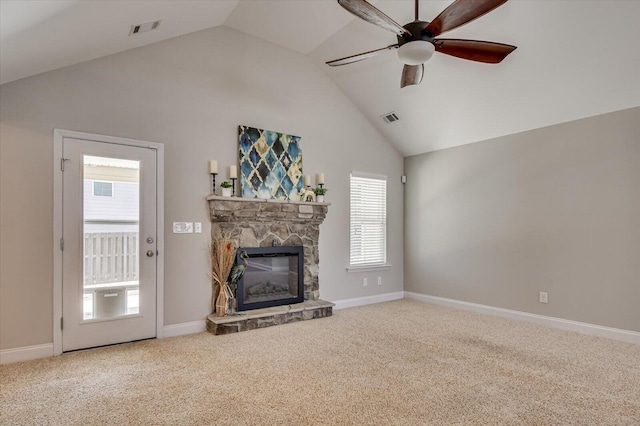 unfurnished living room with a stone fireplace, carpet flooring, and visible vents