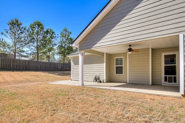 exterior space featuring a patio area, ceiling fan, and fence