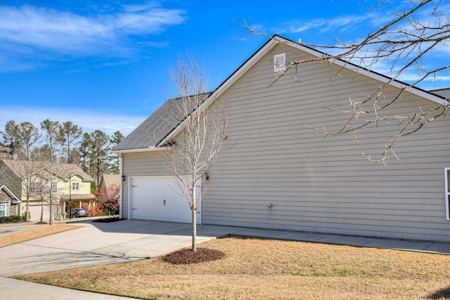 view of home's exterior featuring a garage, roof with shingles, and driveway