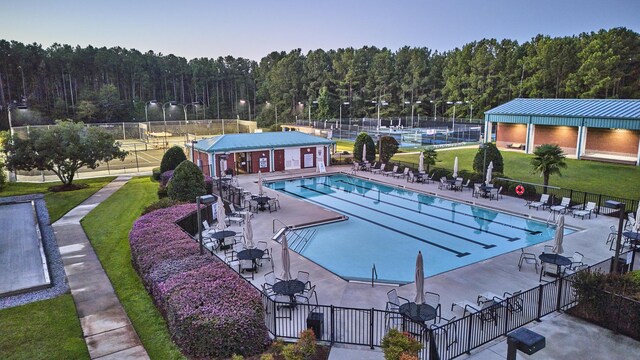 view of swimming pool with a patio area and a lawn