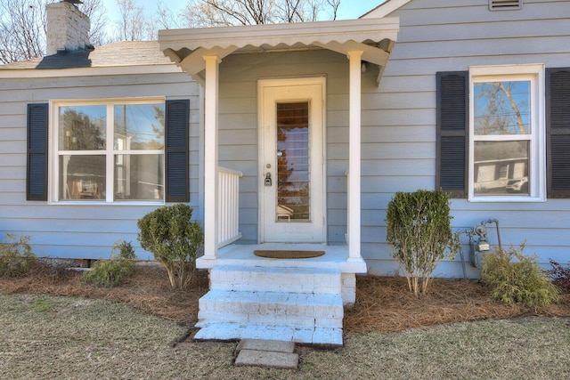 property entrance featuring a chimney