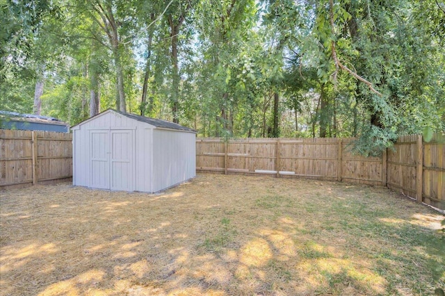 fenced backyard featuring a shed and an outbuilding