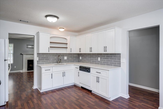 kitchen with white appliances, light countertops, open shelves, dark wood-style floors, and a textured ceiling