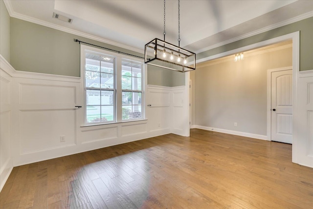 951 Napiers Post Dr, Evans, GA 30809 - unfurnished dining area with a decorative wall, wood-type flooring, wainscoting, ornamental molding, and a chandelier