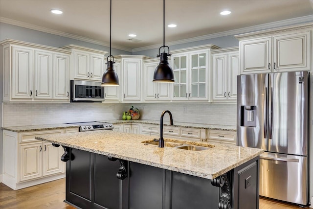 951 Napiers Post Dr, Evans, GA 30809 - kitchen featuring appliances with stainless steel finishes, hanging light fixtures, light stone counters, glass insert cabinets, and a kitchen island with sink