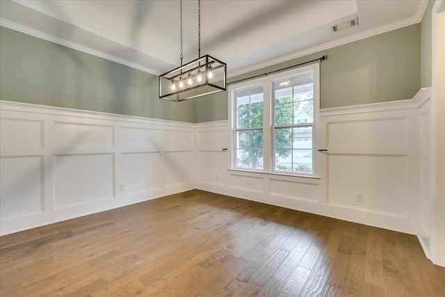 951 Napiers Post Dr, Evans, GA 30809 - unfurnished dining area featuring a decorative wall, a chandelier, a wainscoted wall, ornamental molding, and hardwood / wood-style flooring