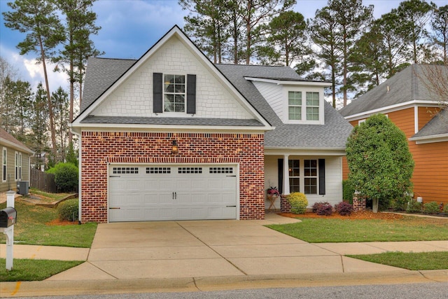 951 Napiers Post Dr, Evans, GA 30809 - traditional home featuring roof with shingles, brick siding, concrete driveway, a garage, and a front lawn