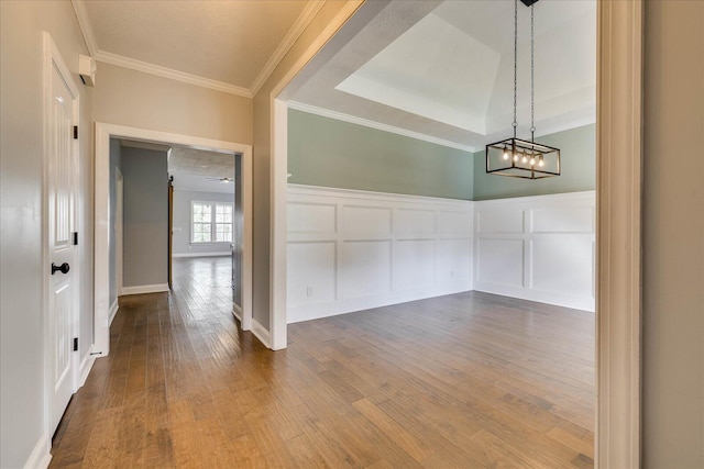 951 Napiers Post Dr, Evans, GA 30809 - empty room with hardwood / wood-style floors, crown molding, a decorative wall, wainscoting, and a chandelier