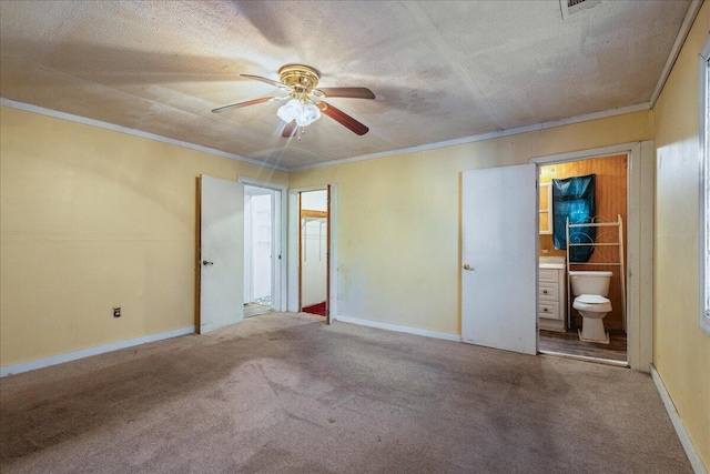 unfurnished bedroom with ensuite bath, carpet flooring, ceiling fan, crown molding, and a textured ceiling