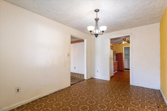 unfurnished room with a chandelier and a textured ceiling