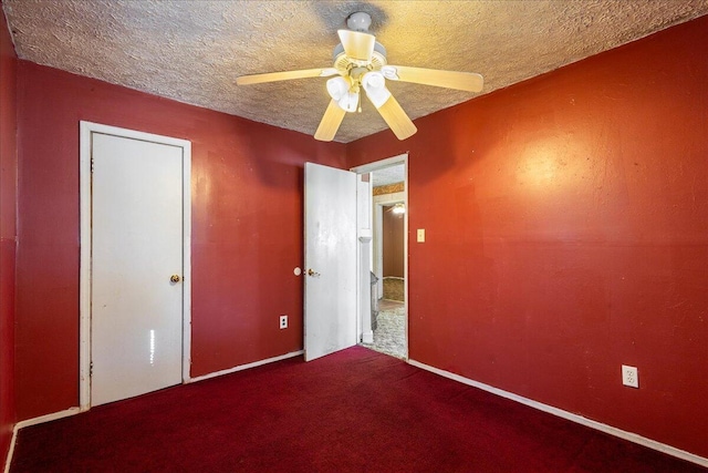 unfurnished bedroom featuring ceiling fan, carpet floors, and a textured ceiling