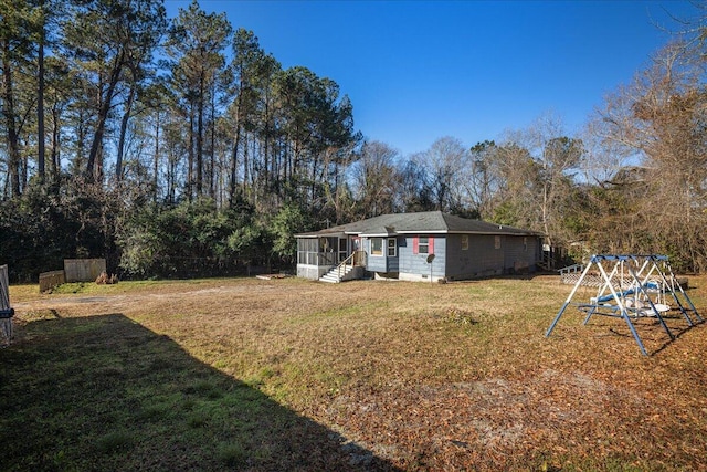 view of yard with a playground and a sunroom