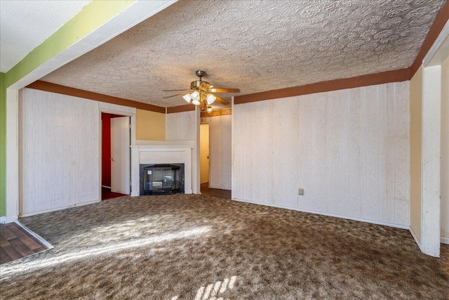 unfurnished living room with ceiling fan, carpet, and a textured ceiling