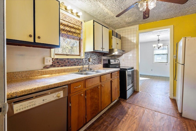 kitchen with sink, stainless steel electric range oven, white refrigerator, dark hardwood / wood-style flooring, and dishwashing machine