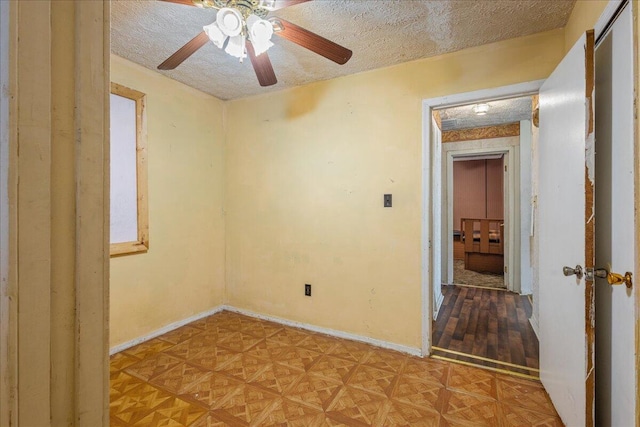 spare room with parquet flooring and a textured ceiling