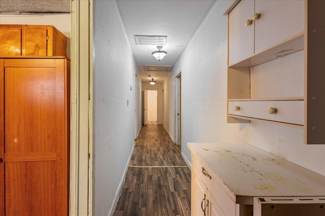 corridor featuring dark hardwood / wood-style flooring