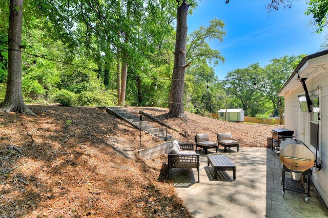 view of patio featuring an outbuilding, grilling area, and a shed