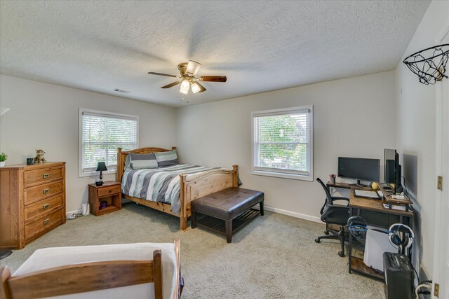 bedroom with visible vents, a textured ceiling, ceiling fan, and carpet floors