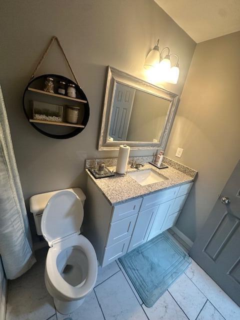bathroom featuring toilet and vanity