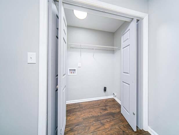 laundry room featuring baseboards, dark wood-style floors, laundry area, and hookup for a washing machine