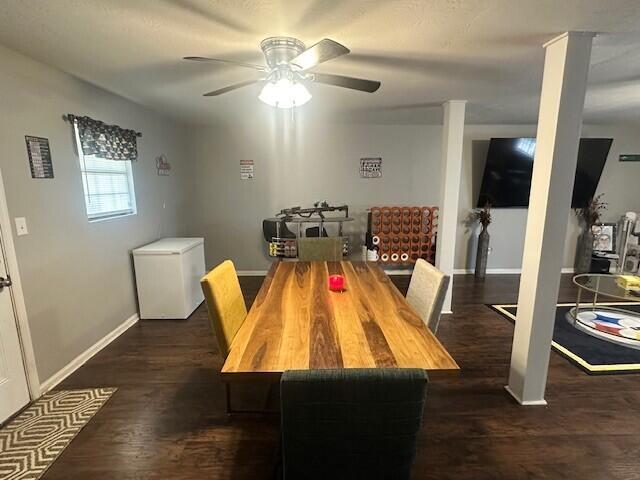 dining area featuring a ceiling fan, baseboards, and wood finished floors