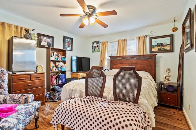 bedroom with a ceiling fan, dark wood finished floors, and baseboards