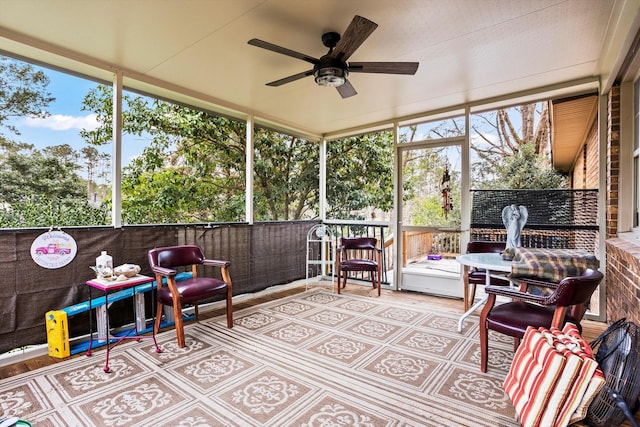 sunroom featuring a ceiling fan