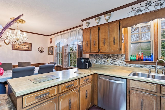 kitchen with dishwasher, a peninsula, light countertops, pendant lighting, and a sink