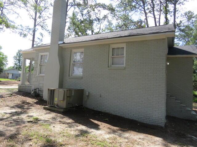 2315 Ridge Rd, Augusta, GA 30906 - view of side of home with a chimney, central AC unit, and brick siding