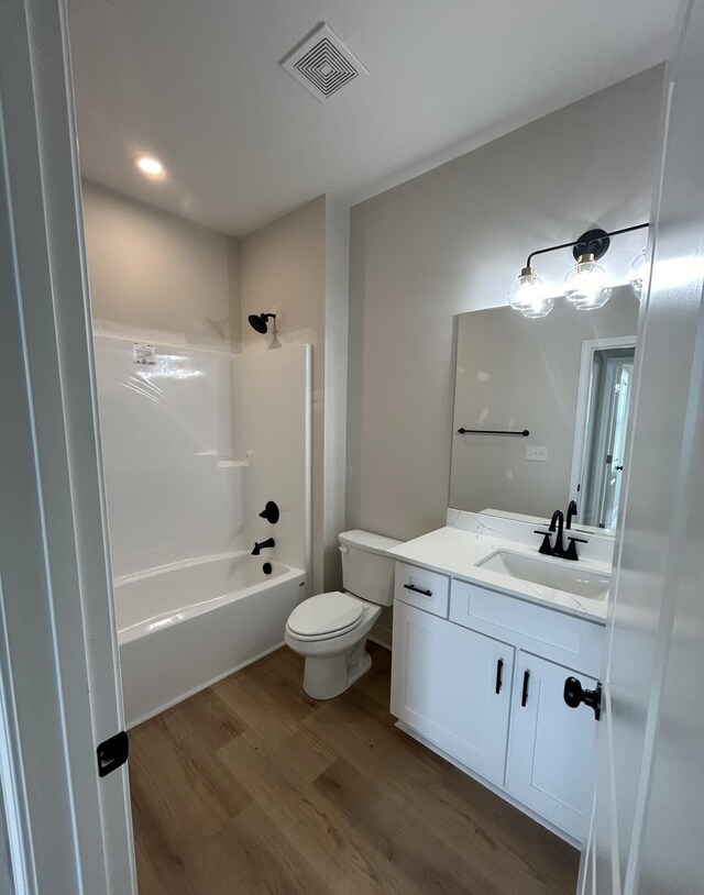410 Williams St, Grovetown, GA 30813 - bathroom with wood finished floors, vanity, toilet, and shower / washtub combination
