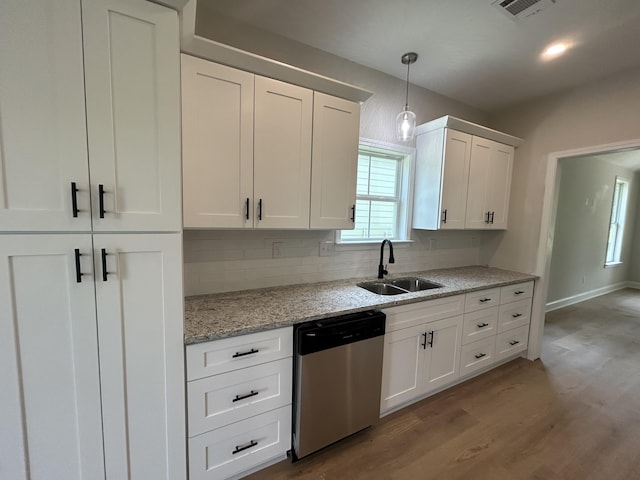 410 Williams St, Grovetown, GA 30813 - kitchen with dishwasher, a sink, light wood finished floors, white cabinets, and tasteful backsplash