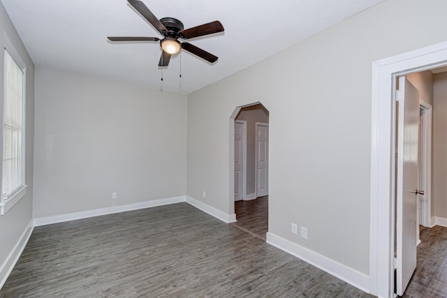 unfurnished room featuring ceiling fan and dark wood-type flooring