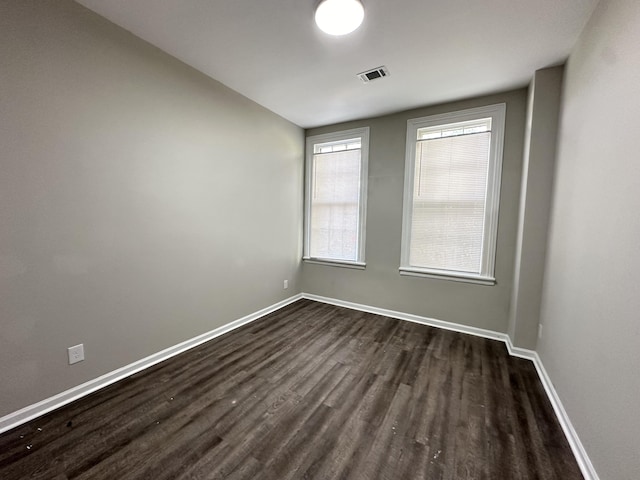 unfurnished room featuring dark hardwood / wood-style floors