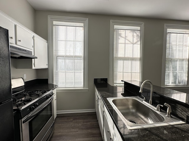 kitchen with white cabinets, stainless steel range with gas cooktop, sink, and a wealth of natural light