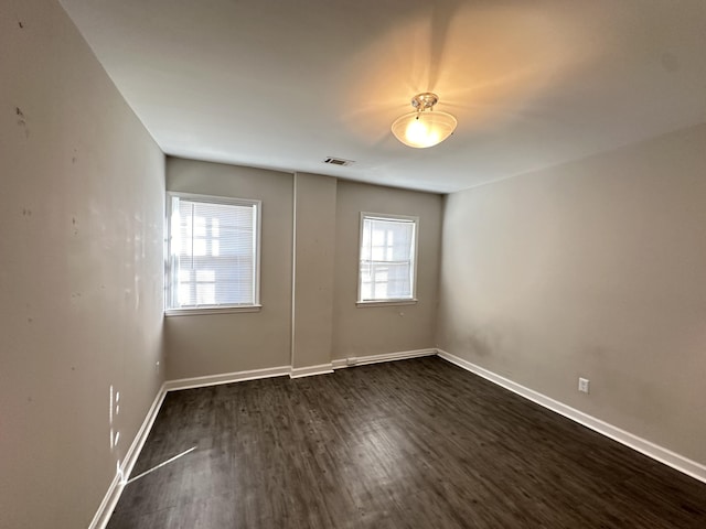 empty room featuring dark hardwood / wood-style flooring