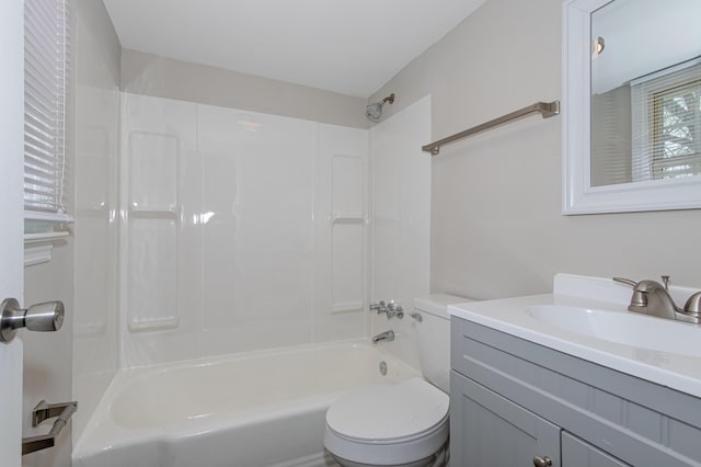 full bathroom featuring vanity, bathtub / shower combination, and toilet