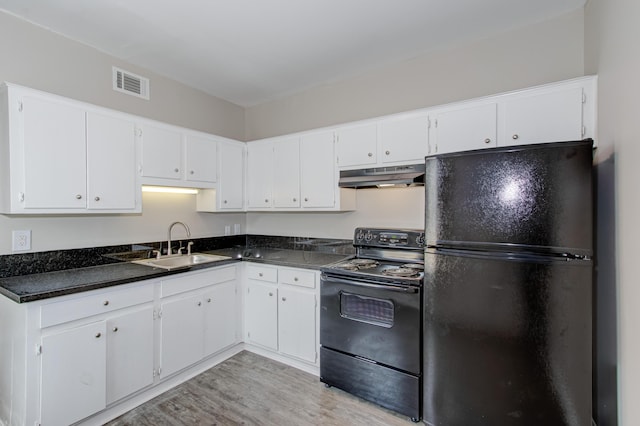 kitchen with sink, light hardwood / wood-style floors, white cabinetry, and black appliances