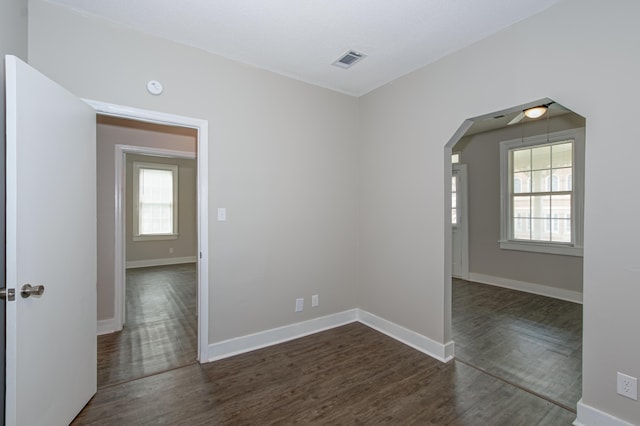 empty room featuring ceiling fan and dark hardwood / wood-style floors