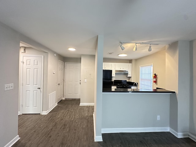 kitchen with kitchen peninsula, track lighting, black appliances, white cabinets, and dark hardwood / wood-style floors