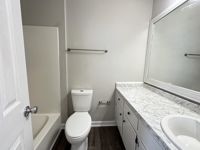 bathroom with vanity, toilet, and wood-type flooring