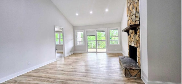 1306 Dominica Dr, Augusta, GA 30909 - unfurnished living room featuring high vaulted ceiling, light wood-style flooring, a stone fireplace, baseboards, and recessed lighting
