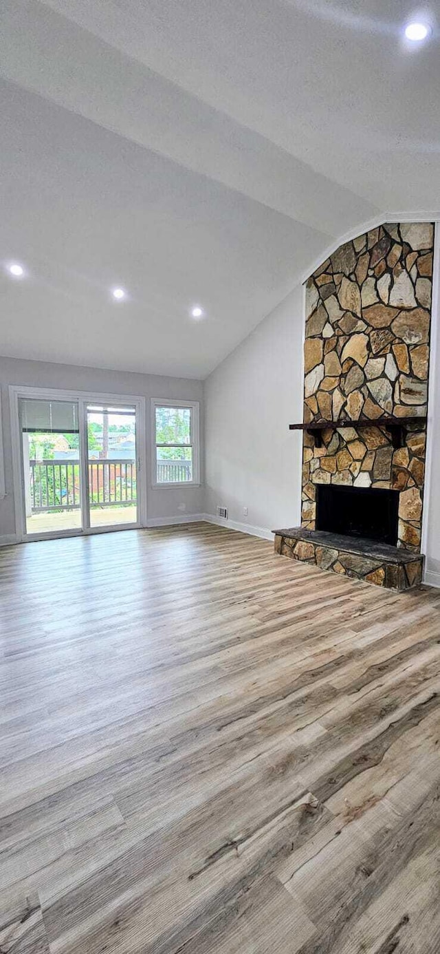 1306 Dominica Dr, Augusta, GA 30909 - unfurnished living room featuring lofted ceiling, wood finished floors, a fireplace, baseboards, and recessed lighting