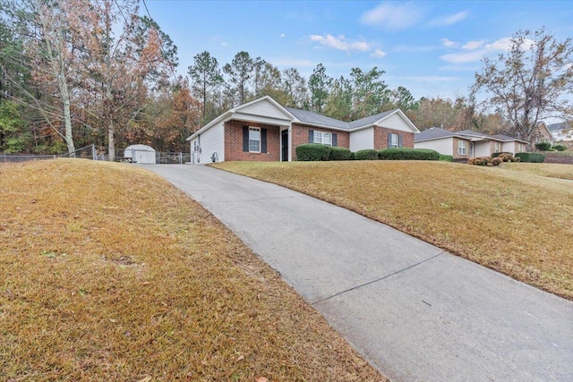 single story home with a front yard and an outdoor structure