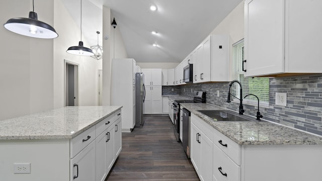 4593 Windsor Spring Rd, Hephzibah, GA 30815 - kitchen with stainless steel appliances, dark wood finished floors, decorative backsplash, white cabinetry, and vaulted ceiling
