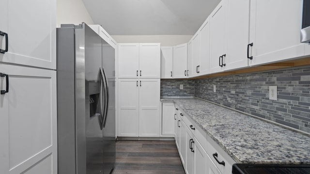 4593 Windsor Spring Rd, Hephzibah, GA 30815 - kitchen featuring stainless steel refrigerator with ice dispenser, light stone counters, backsplash, white cabinets, and dark wood-style floors