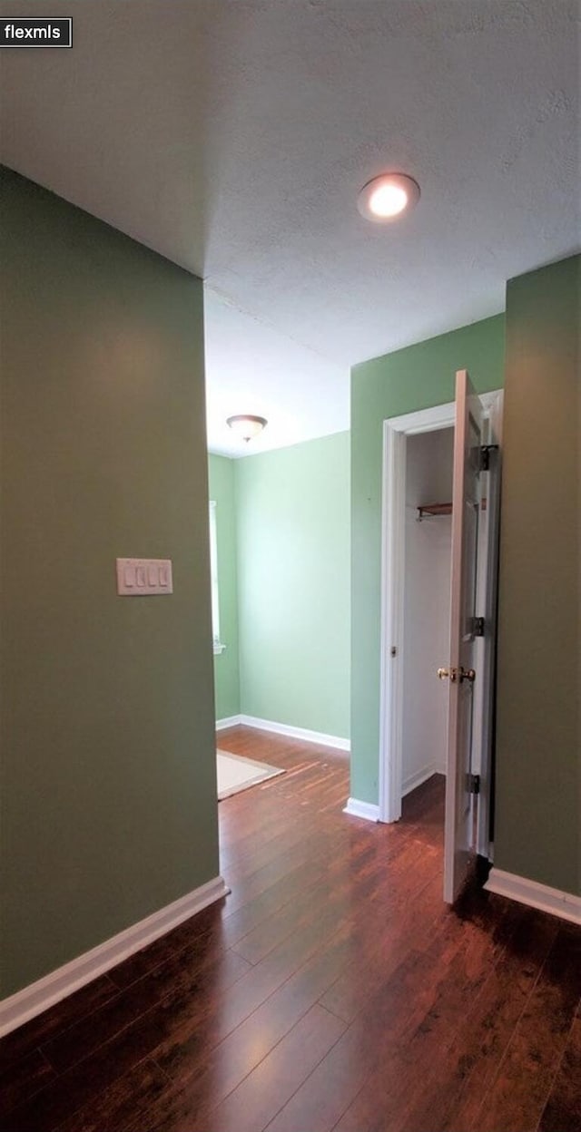 corridor featuring dark hardwood / wood-style floors