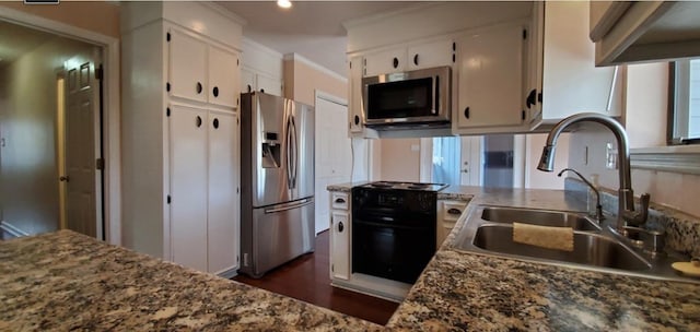 kitchen featuring sink, appliances with stainless steel finishes, stone countertops, white cabinets, and ornamental molding